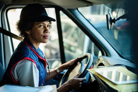 A professional OCI driver beside his vehicle